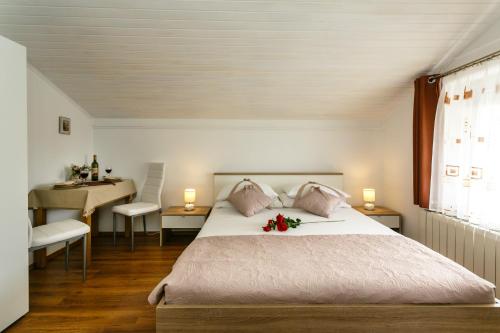 a bedroom with a bed with flowers on it at Apartmani Cvelic in Malinska