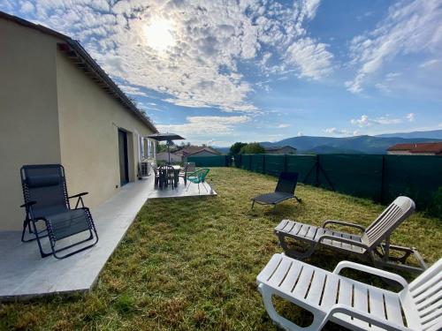 un patio con sedie, un tavolo e sedie di LA Conciergerie 05 Villa Kylsha Rosans WiFi Terrasse Confort a Rosans
