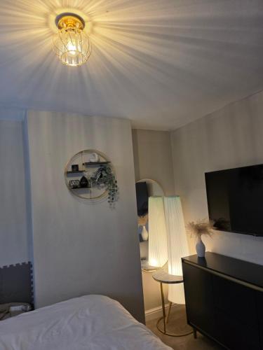 a bedroom with a bed and a mirror and a lamp at Stunning property with Summer house in Bescot