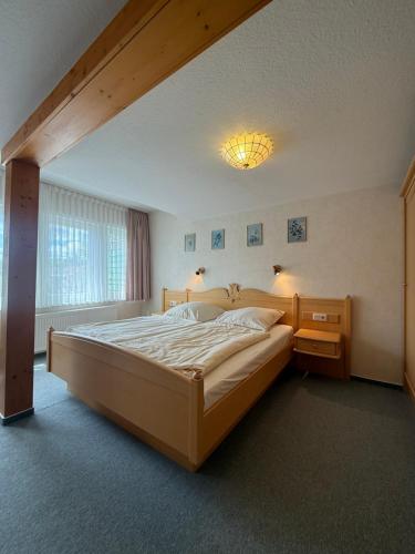 a bedroom with a large bed and a window at Hotel Berliner Hof in Braunlage