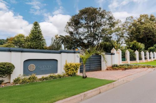 a white fence with a sign that reads sherify at Serene Guesthouse in Middelburg