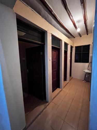 a hallway of a building with two doors at Kijijini GuestHouse Gazi in Gazi