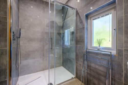 a bathroom with a shower with a glass door at The Bolt Hole in Silverdale