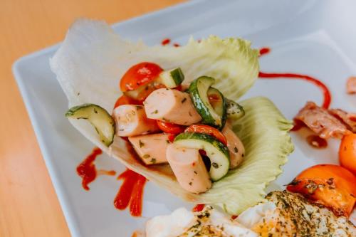 a plate of food with shrimp and vegetables on it at Serene Guesthouse in Middelburg