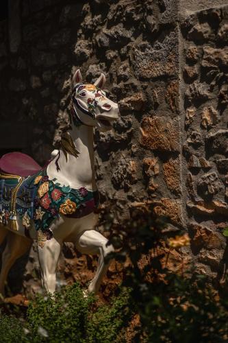 a figurine of a horse in front of a building at Rubeas Towers - Pyrgos Towers Complex in Pírgos