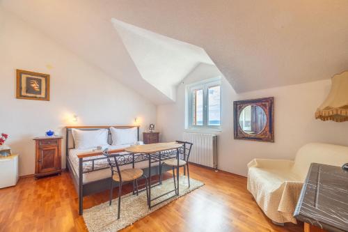 a bedroom with a bed and a table in a room at Apartments and Rooms LEA in Bol