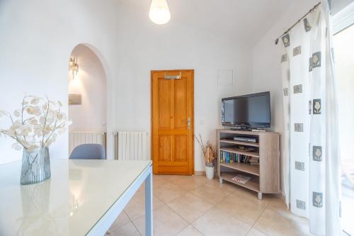 a living room with a tv and a table at Apartments and Rooms LEA in Bol