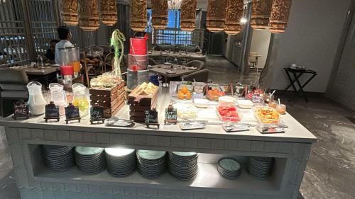 a table with plates and food on top of it at Grand Mirage Dhanbad, a member of Radisson Individuals in Dhanbād