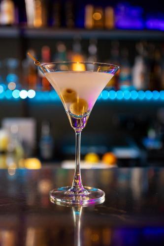 a martini glass sitting on top of a bar at Blakeney House in Blakeney