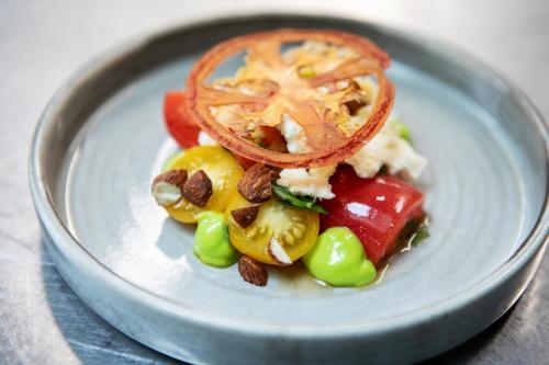 a plate of food with vegetables on a table at Blakeney House in Blakeney