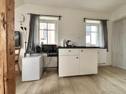 a living room with white cabinets and a desk at Vlevo Dole 7 by Správa ubytka in Rokytnice nad Jizerou