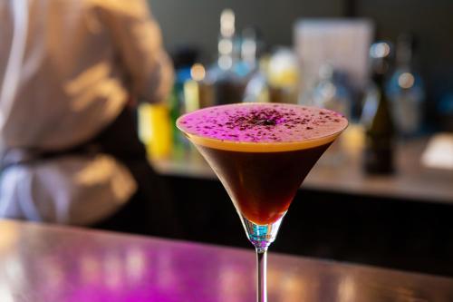 a cocktail sitting on top of a bar at Blakeney House in Blakeney