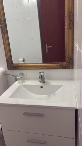 a bathroom with a white sink and a mirror at ElStefanino House in Eforie Nord