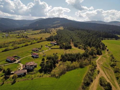 an aerial view of a house in a green field at Forest Hide Tiny House in Covasna