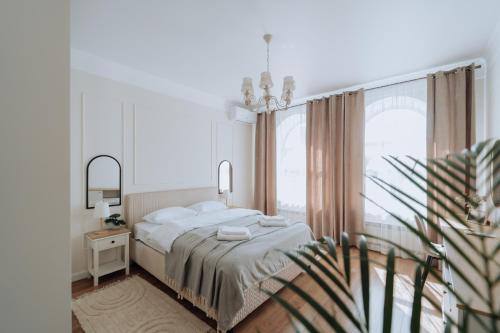 a bedroom with a bed and a large window at Central 2BR on Petru Movilă Walk to It All in Chişinău