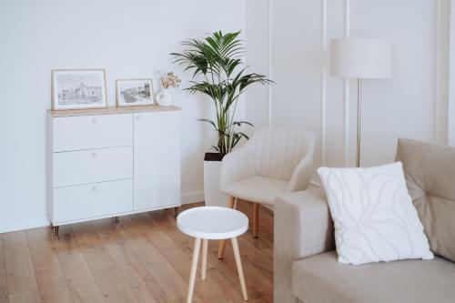a living room with a couch and a chair at Central 2BR on Petru Movilă Walk to It All in Chişinău
