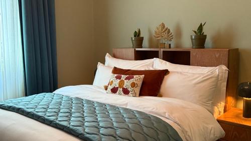 a bed with a blue blanket on top of it at Hotel Lost Ashrafieh in Beirut