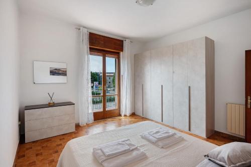 a white bedroom with a large bed and a window at Zio Gennaro Residence in Agerola