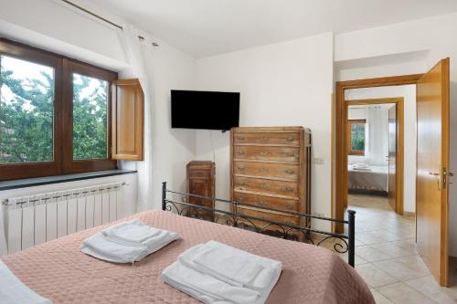a bedroom with a bed with two towels on it at Zio Gennaro Residence in Agerola