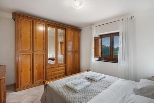 a bedroom with a bed with two towels on it at Zio Gennaro Residence in Agerola