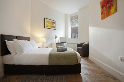 Ένα ή περισσότερα κρεβάτια σε δωμάτιο στο Cosy home in Hull Centre Flat 1