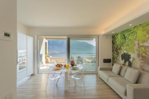a living room with a table and a couch at Valarin Luxury Apartments & Wellness, Vercana by Rent All Como in Vercana