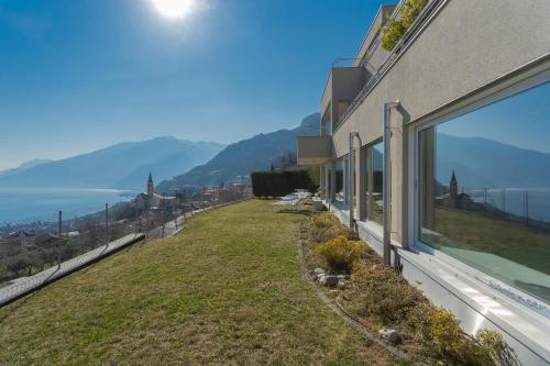 a house with a large window on the side of it at Valarin Luxury Apartments & Wellness, Vercana by Rent All Como in Vercana