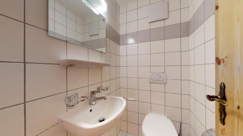 a white bathroom with a sink and a toilet at Pracondu 2 307 - OUTDOOR & FUN charming apartment in Nendaz