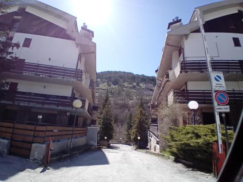 a street in front of two tall buildings at Luna Reale Roccaraso apt in Roccaraso
