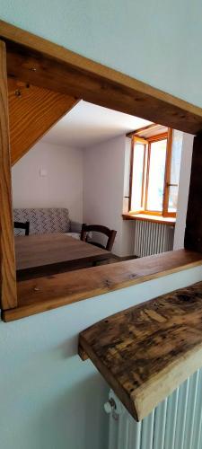 a small room with a bed and a table at CA' DEL PITUR Apartments B&B Cicogna in Cicogna