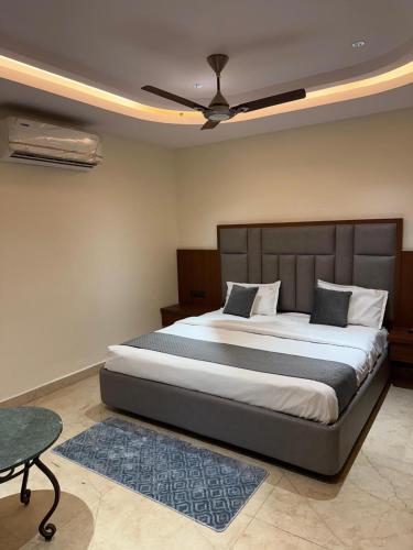 a bedroom with a large bed with a ceiling fan at Agarwal's Residency in Visakhapatnam