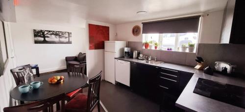 a kitchen with a table and a dining room at megiiceland in Njarðvík