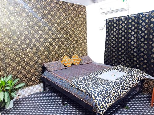 a small bed in a room with a wall at The Hotel Villa in Sivasagar