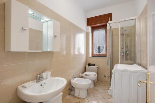 a bathroom with a white sink and a toilet at Zio Gennaro Residence in Agerola