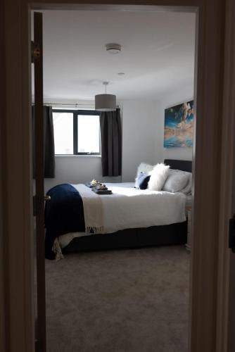a bedroom with a large bed and a window at 1BR w Sofa Bed Private Yard in Exmouth
