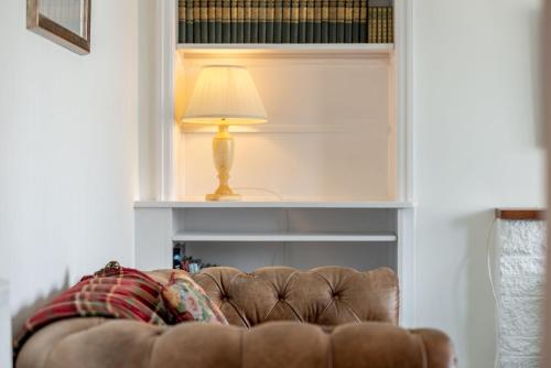 a couch in a living room with a lamp at Livingstone Crescent - No 5 in St. Andrews