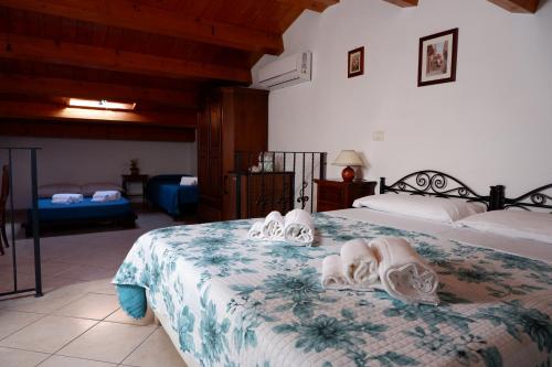 a bedroom with two beds with towels on them at Sikania Residence in Siracusa