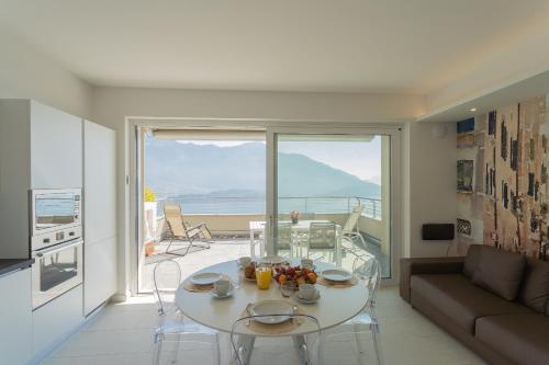 a living room with a white table and a couch at Valarin Luxury Apartments & Wellness, Vercana by Rent All Como in Vercana