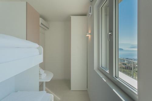 a room with a window with a view of the city at Valarin Luxury Apartments & Wellness, Vercana by Rent All Como in Vercana