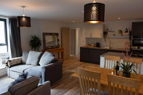 a living room with a couch and a table at Cozy City Stay 2BR with Sofa Bed in Exmouth