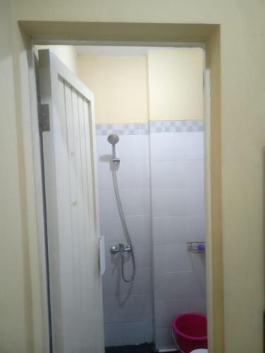 a bathroom with a shower and a red toilet at Atmawidjaja house in Jakarta