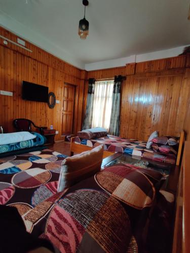 a room with a bunch of beds in it at Miryok Homes in Mirik