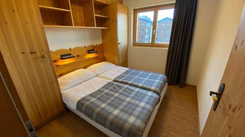 a small bedroom with a bed and a window at Pracondu 1 401 - OUTDOOR & FUN apartment 8 pers in Nendaz