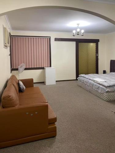 a living room with a couch and a bed at a 别墅大床间毗邻公园和公交车站 in Melbourne