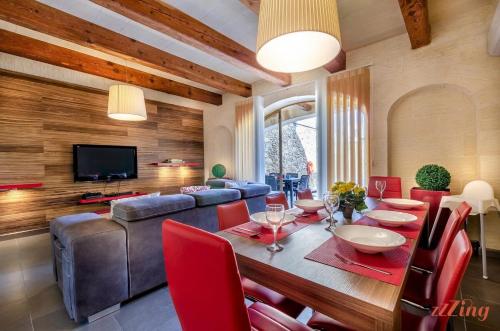 a living room with a table and chairs and a television at Peaceful Farmhouse Retreat with Pool & Sun Lounger in Xagħra