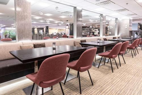 a row of tables and chairs in a restaurant at Scandic Julia in Turku