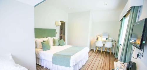 a hotel room with a bed and a mirror at The Casa Hotel, Sure Hotel Collection by Best Western in Yateley