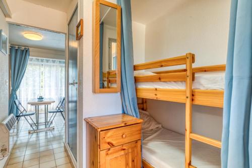 a room with two bunk beds and a mirror at Les saules in Le Grau-dʼAgde