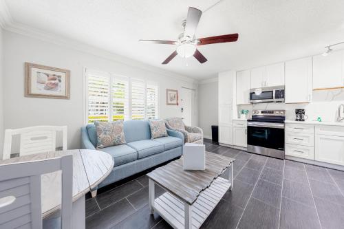 a living room with a couch and a ceiling fan at Gulf Holiday By Beachside Management in Siesta Key