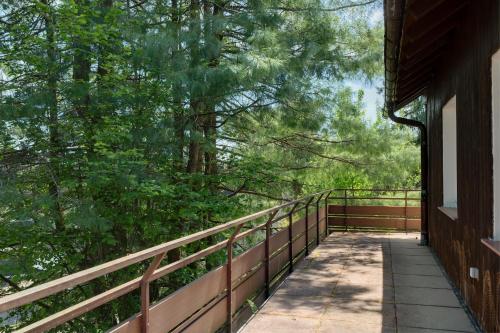a walkway on a building with a fence and trees at Gästehaus Hirzel in Bad Wildbad
